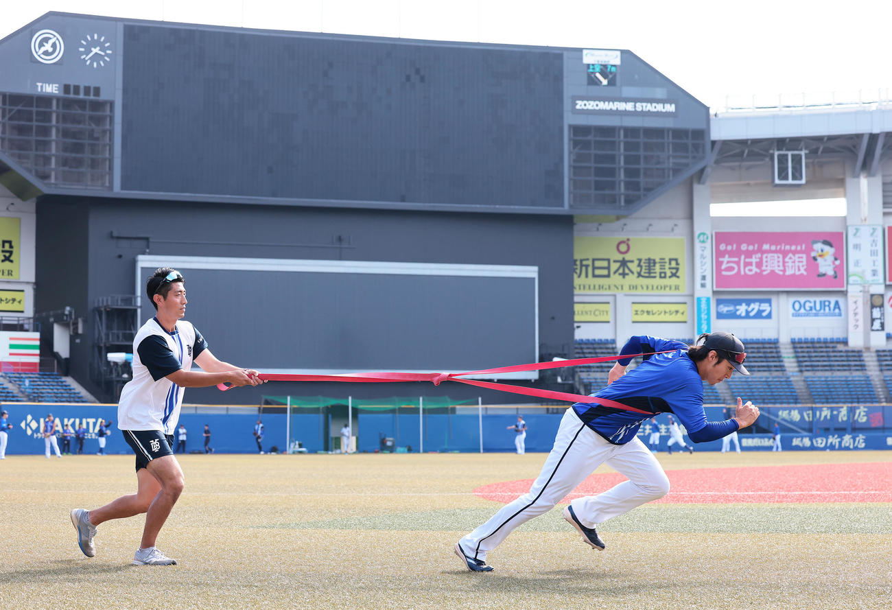 試合前、チューブトレーニングを行うDeNA度会（右）（撮影・足立雅史）