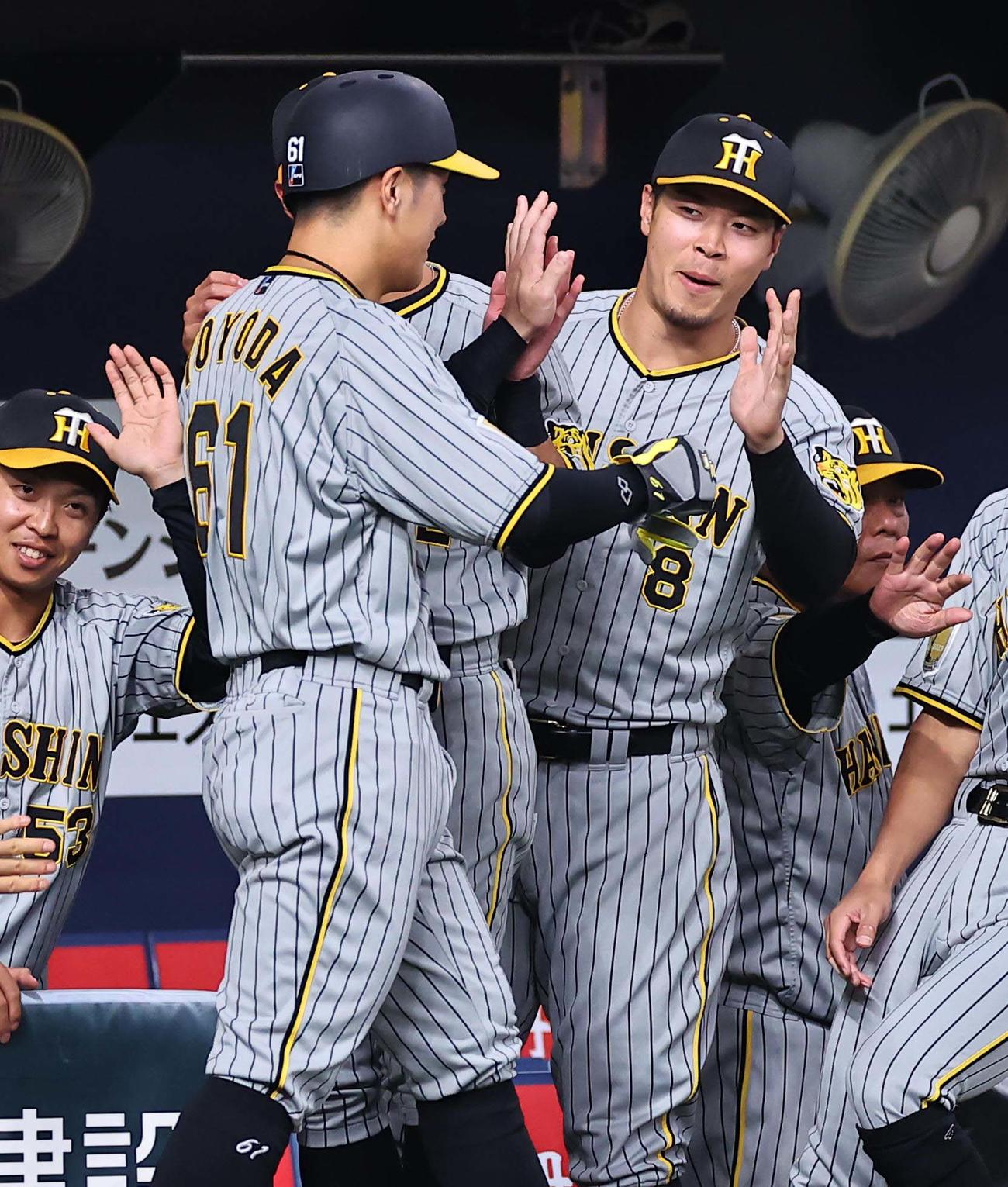 オリックス対阪神　4回表阪神1死一、三塁、佐藤輝（右）は木浪の適時二塁打で生還した豊田をハイタッチで出迎える（撮影・上田博志）