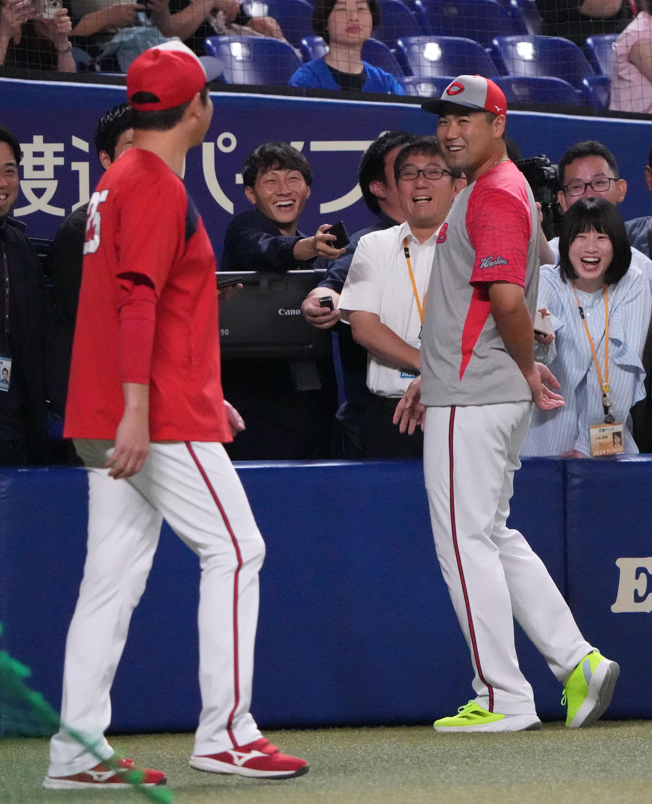 中日対広島　試合前、取材対応中に新井監督からいじられる末包（手前・右）（撮影・森本幸一）