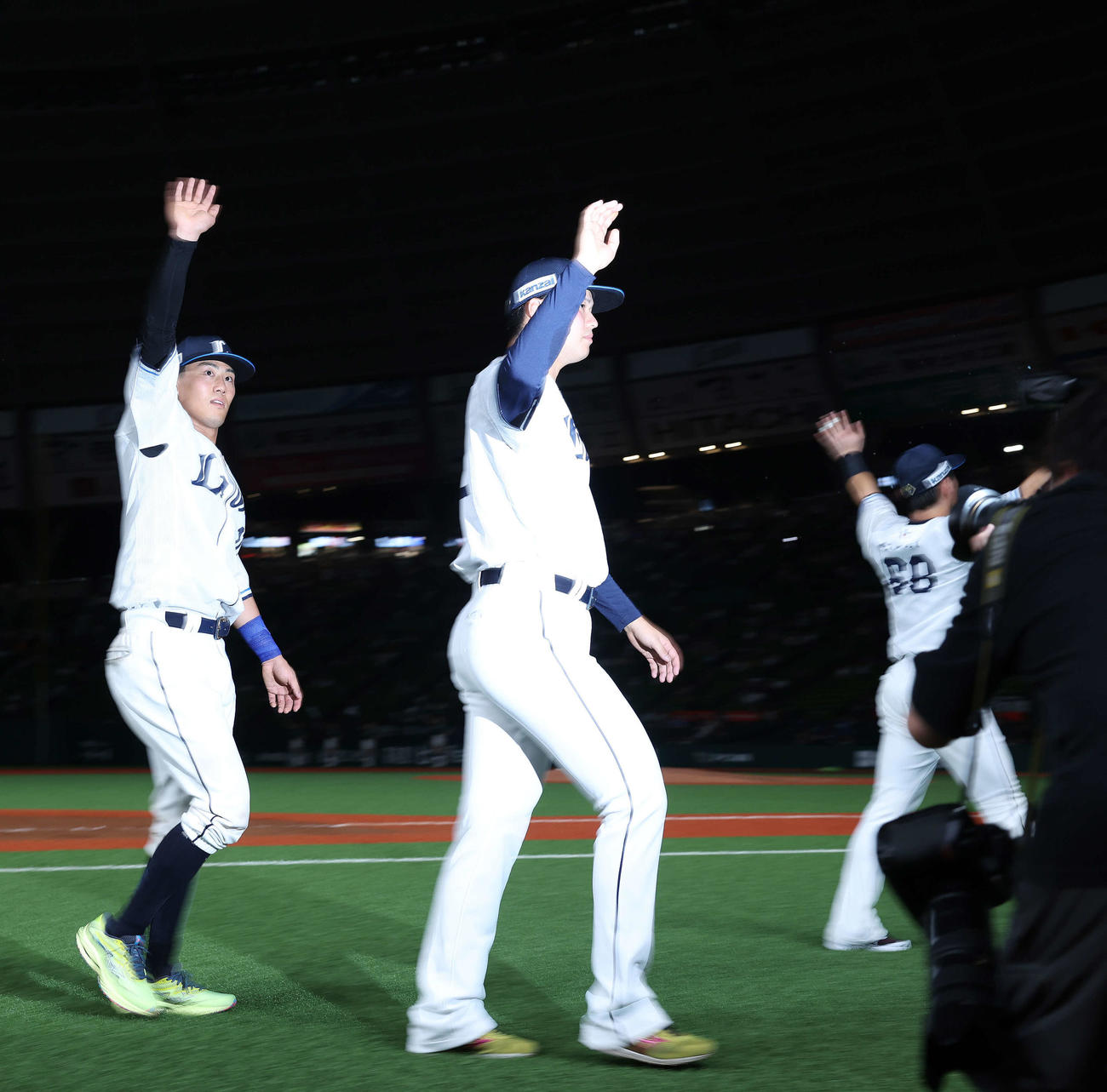 西武対日本ハム　日本ハムに勝利し、観客席にあいさつしながら引き揚げる西武の、左から牧野、渡辺、岸（撮影・河田真司）