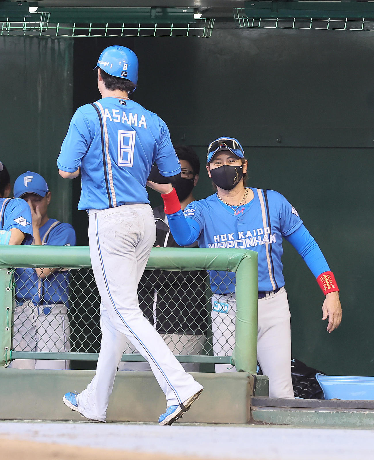 西武対日本ハム　1回表日本ハム1死一、三塁、田宮の左犠飛で生還した浅間大基を笑顔で迎える新庄監督（撮影・足立雅史）