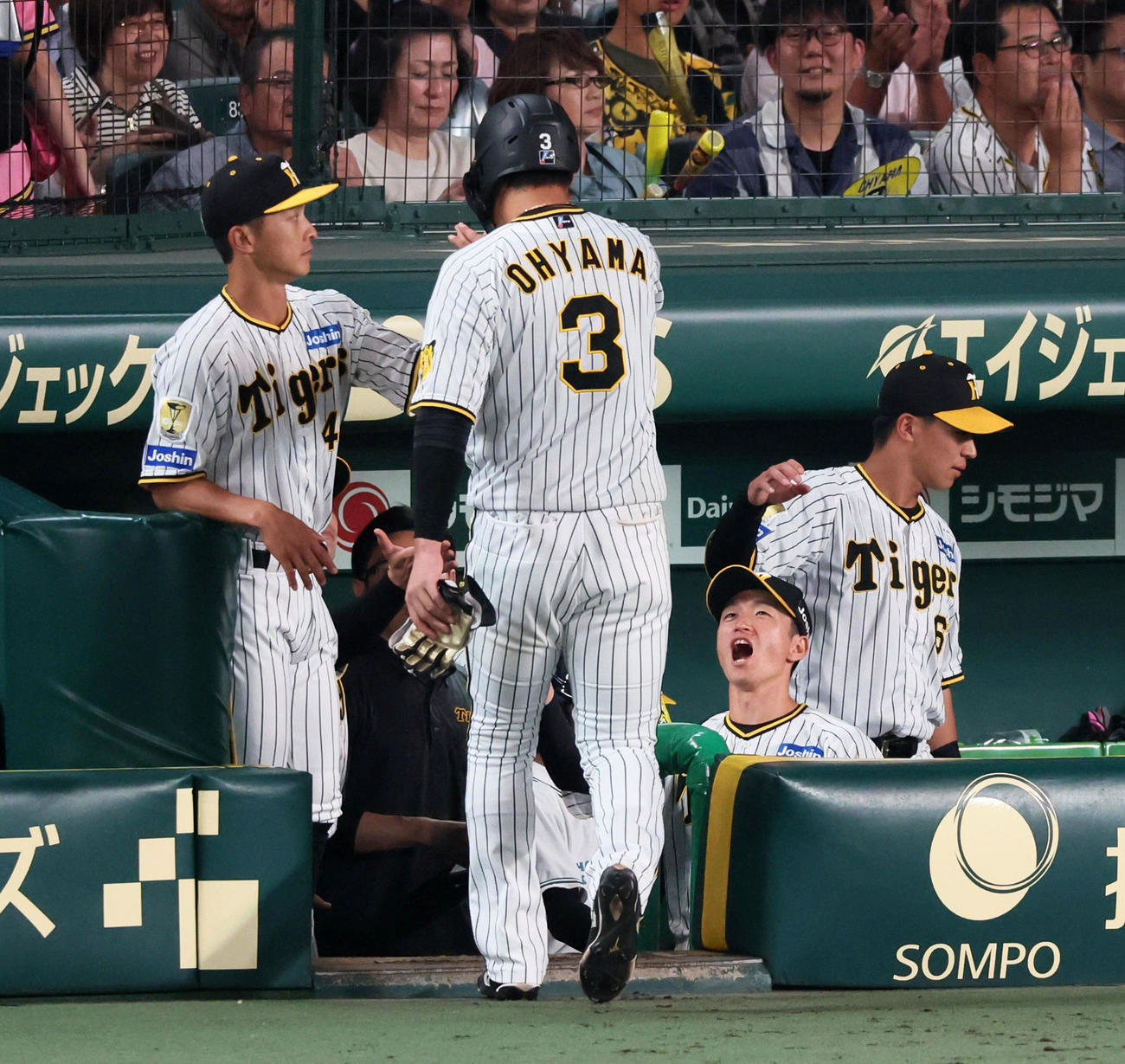 阪神対中日　7回裏阪神無死一、三塁、大山は左適時打を放ち相手投手交代で一旦ベンチへ戻ると近本（右）らナインが声を掛けて祝福する（撮影・加藤哉）