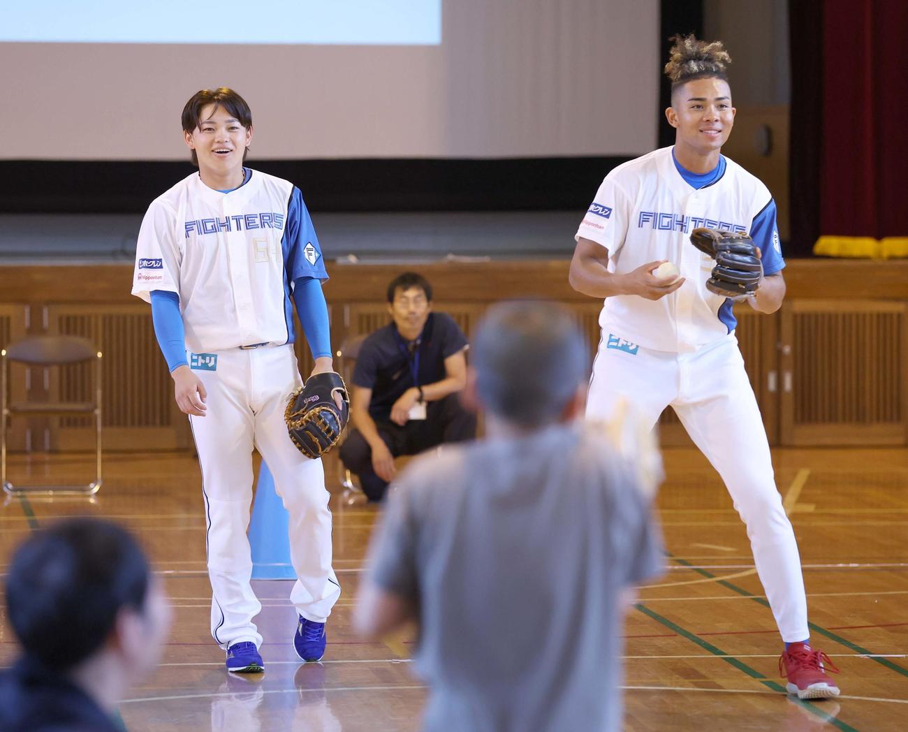 札幌市内の小学校を訪問した日本ハム田宮（左）と水谷は子どもたちとキャッチボールする（撮影・黒川智章）