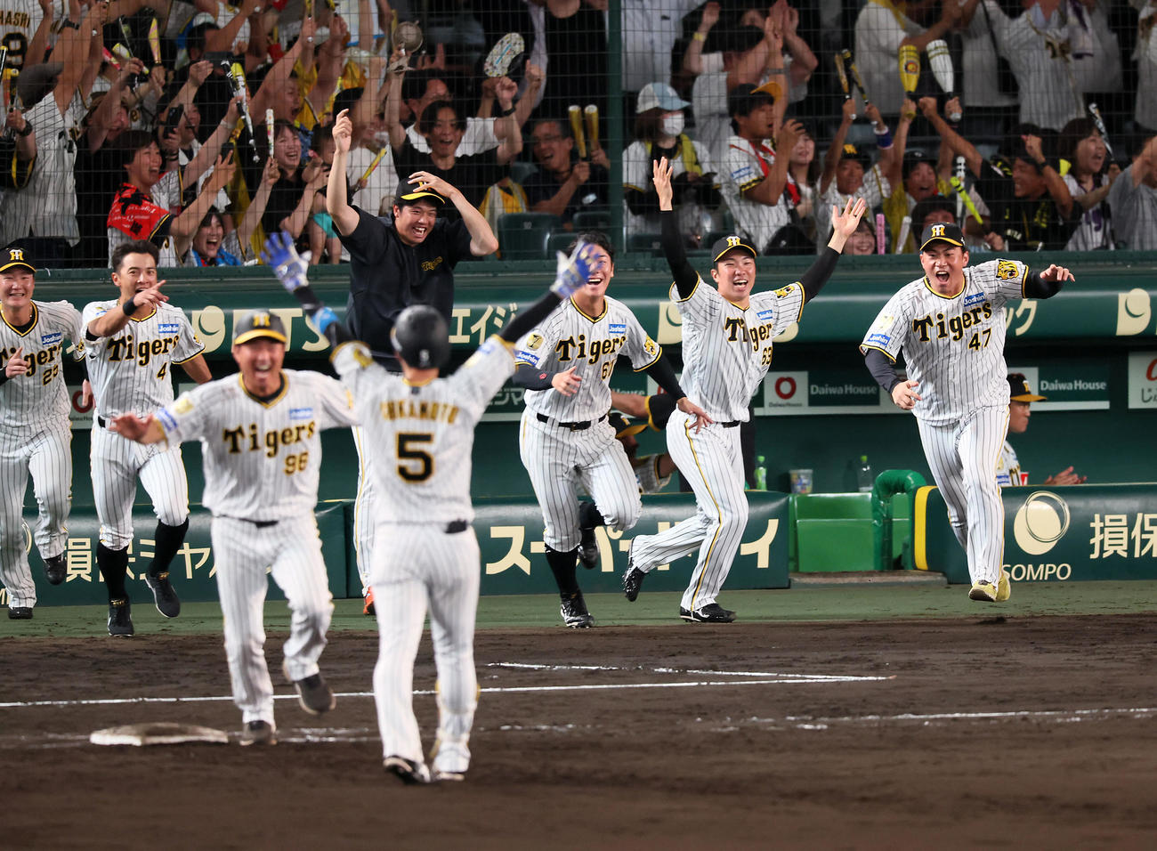 阪神対ヤクルト　9回裏阪神2死満塁、近本（5番）のサヨナラ適時打に笑顔で駆け寄る才木（奥中央）らナイン（撮影・加藤哉）
