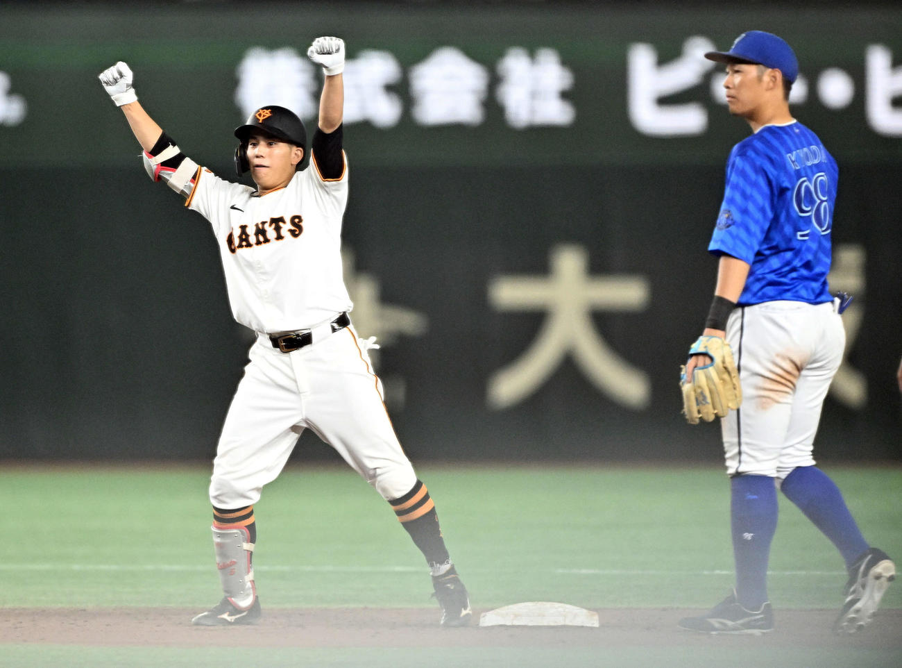 巨人対DeNA 6回裏巨人2死満塁、3点適時二塁打を放った門脇（左）はガッツポーズする。遊撃手京田（撮影・滝沢徹郎）