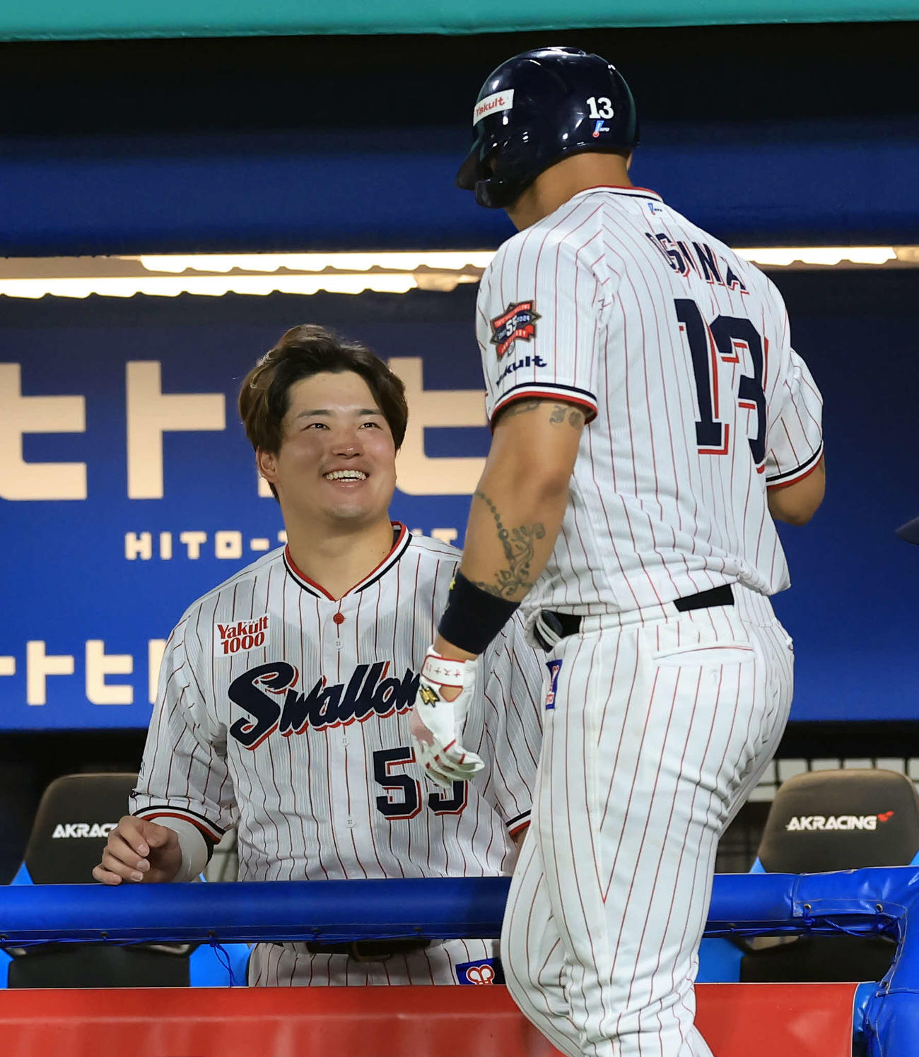 ヤクルト対DeNA 6回裏ヤクルト無死、オスナ（手前）が同点ソロ本塁打を放ち笑顔で迎える村上（撮影・浅見桂子）