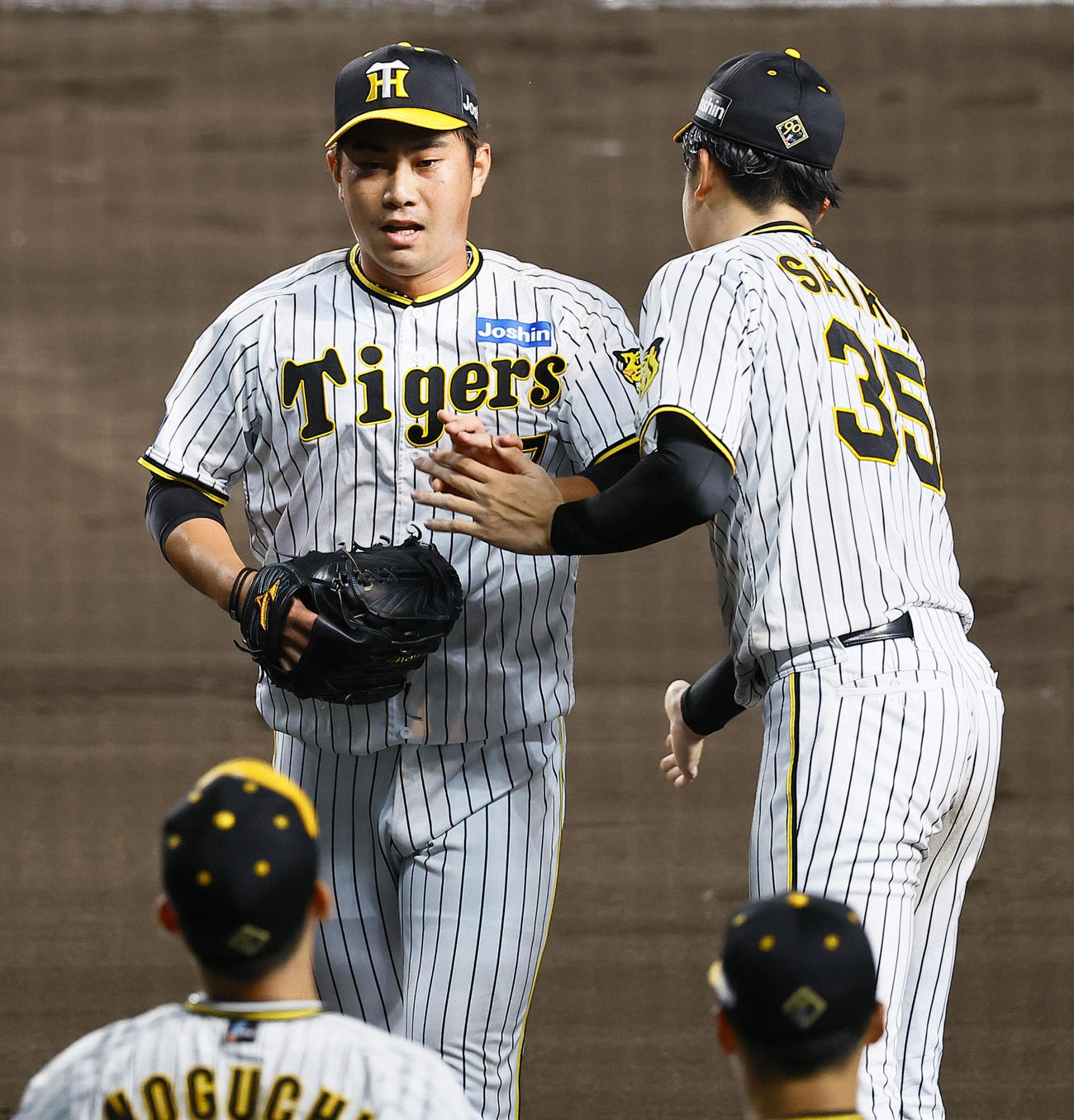 阪神対巨人　7回を終え才木（右）とタッチを交わす桐敷（撮影・藤尾明華）