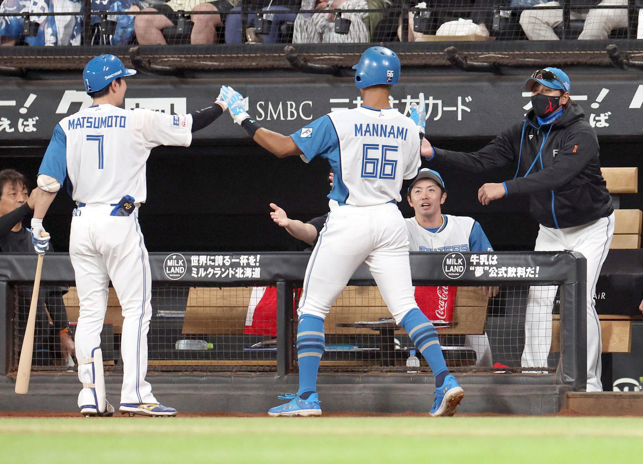 日本ハム対ロッテ　2回裏日本ハム無死二、三塁、伏見のスクイズで生還した三塁走者の万波を出迎える新庄監督（右）（撮影・佐藤翔太）