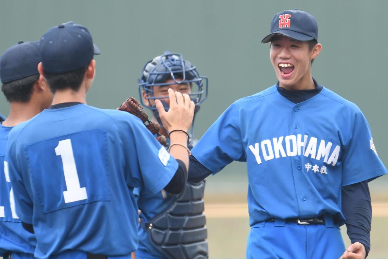中本牧の小林鉄太郎（右）は完封リレーを締めくくりにっこり。背番号1は先発の鈴木。中央は陶山