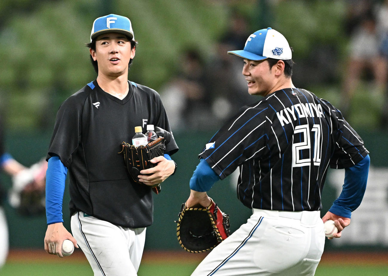 西武対日本ハム　試合前練習を終え引き揚げる日本ハム北山。右は守備練習する清宮（撮影・滝沢徹郎）