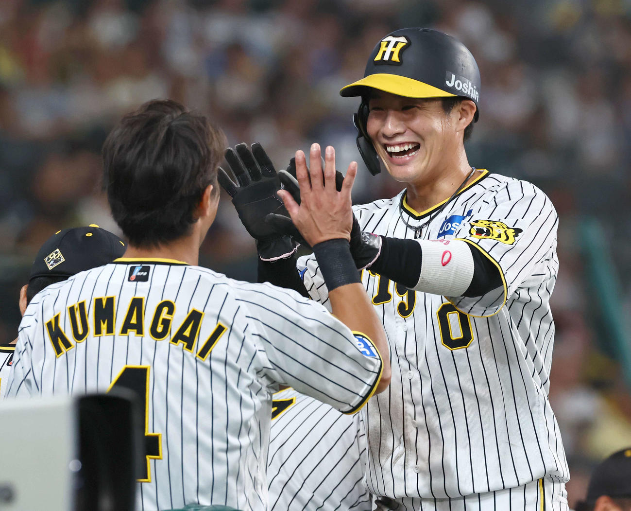 阪神対中日　7回裏阪神1死三塁、近本の適時打で生還した木浪はナインの出迎えに笑顔を見せる（撮影・上田博志）
