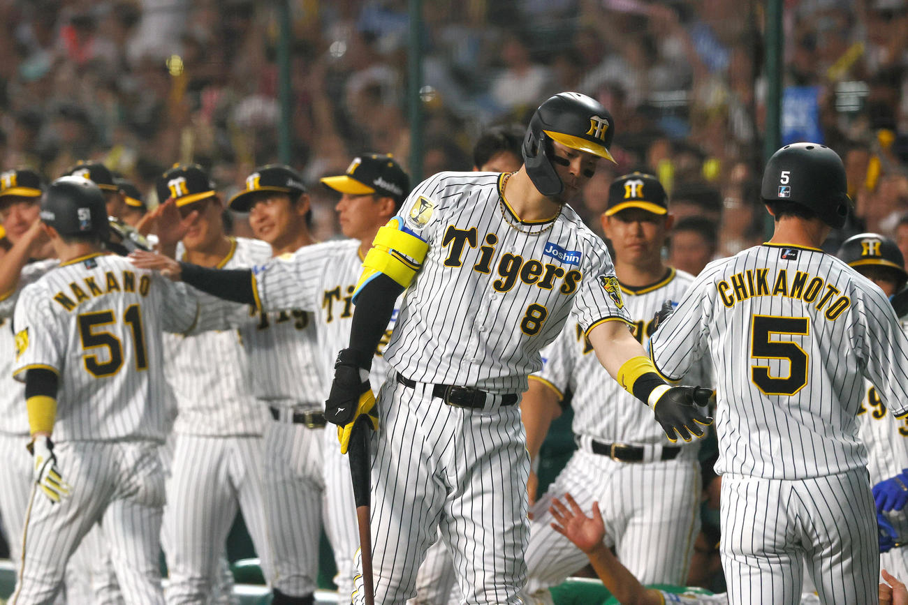 阪神対中日　1回裏阪神無死一、二塁、佐藤輝（左）は森下の右適時2点二塁打で生還の近本を出迎える（撮影・上山淳一）