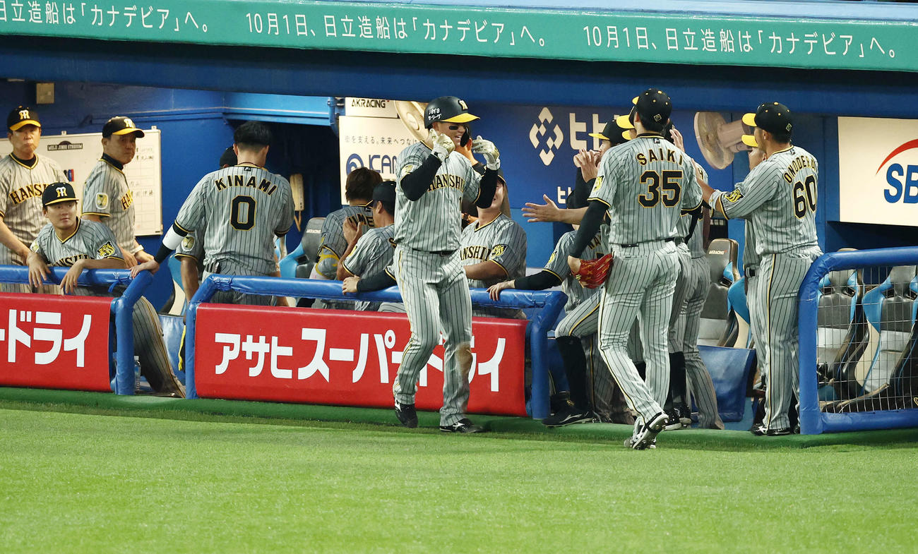ヤクルト対阪神　1回表阪神1死二塁、大山の中前適時打で生還し、チームメートに迎えられる森下（中央）（撮影・河田真司）