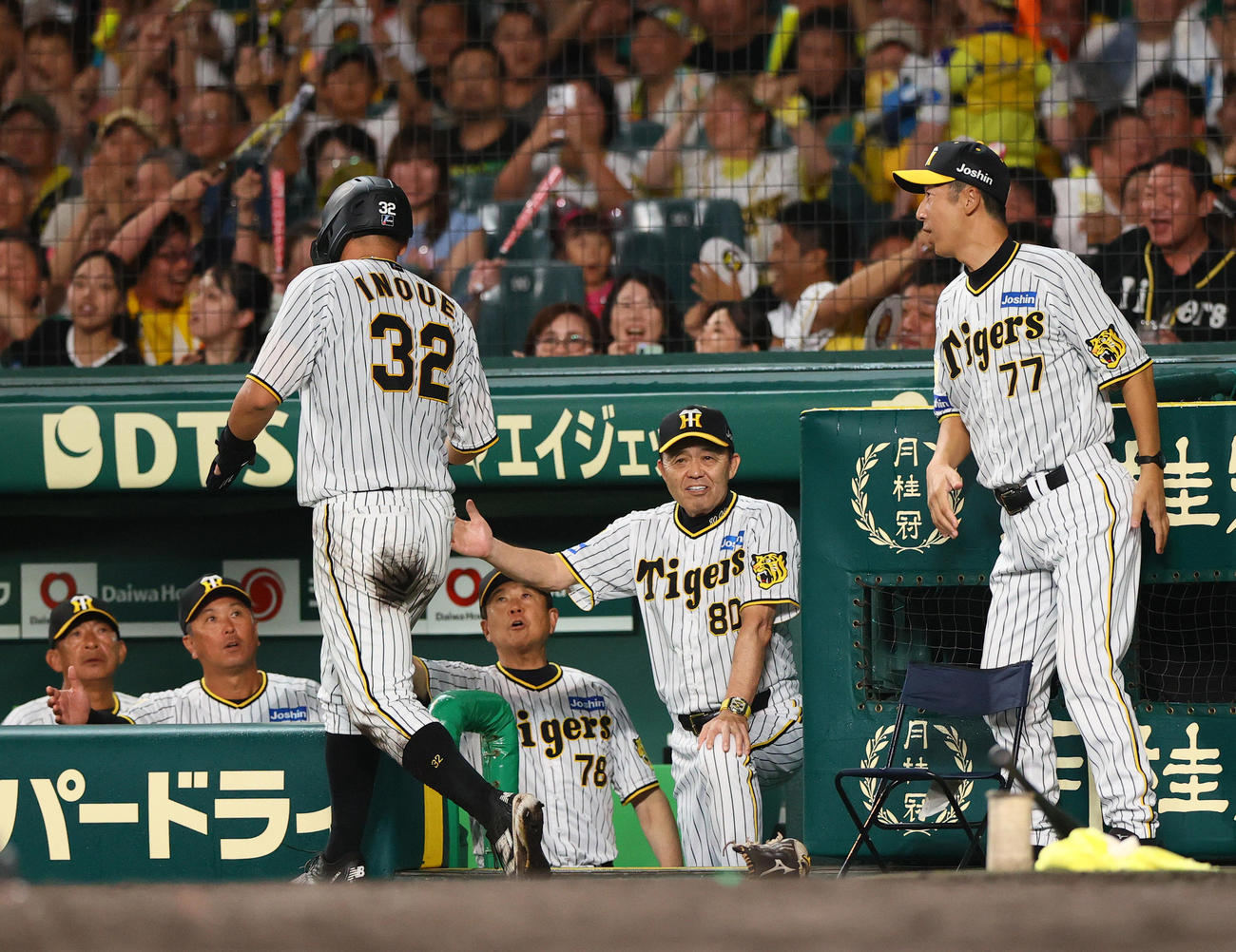 阪神対DeNA 5回裏阪神1死一、三塁、岡田監督（右から2人目）は青柳のセーフティースクイズで生還した井上（手前）を出迎える（撮影・上山淳一）