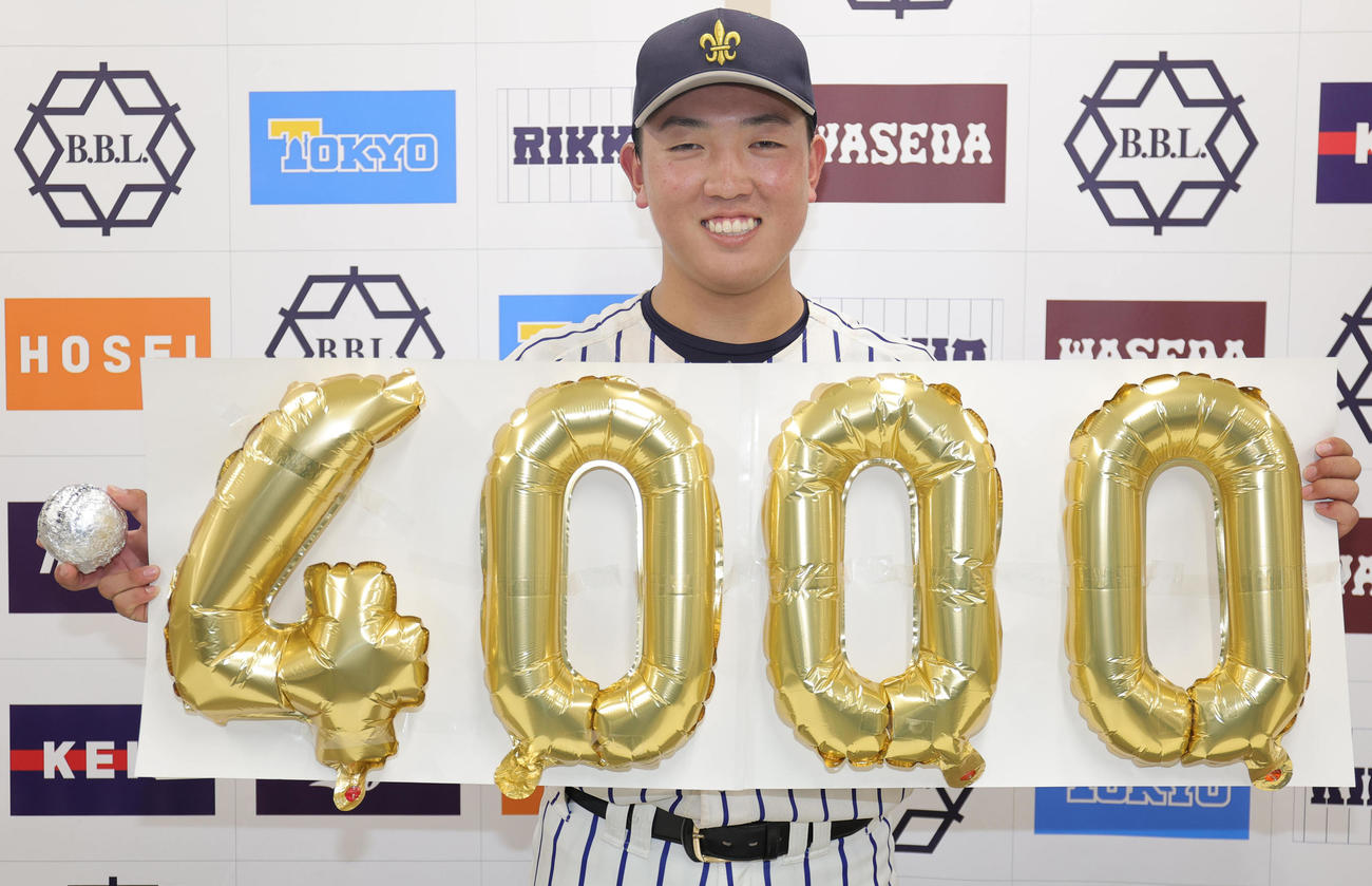 立大対慶大　リーグ通算4000号となる本塁打を放った立大・小林隼は、記念ボードと記念球を手に笑顔（撮影・野上伸悟）