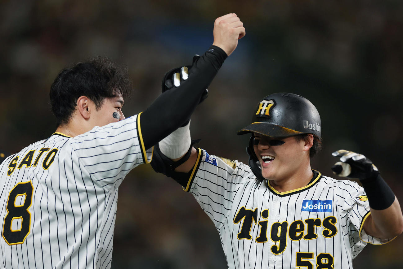 阪神対ヤクルト　2回裏阪神1死、2者連続の本塁打を放ち、迎えた佐藤輝（左）とタッチを交わす前川（撮影・前田充）
