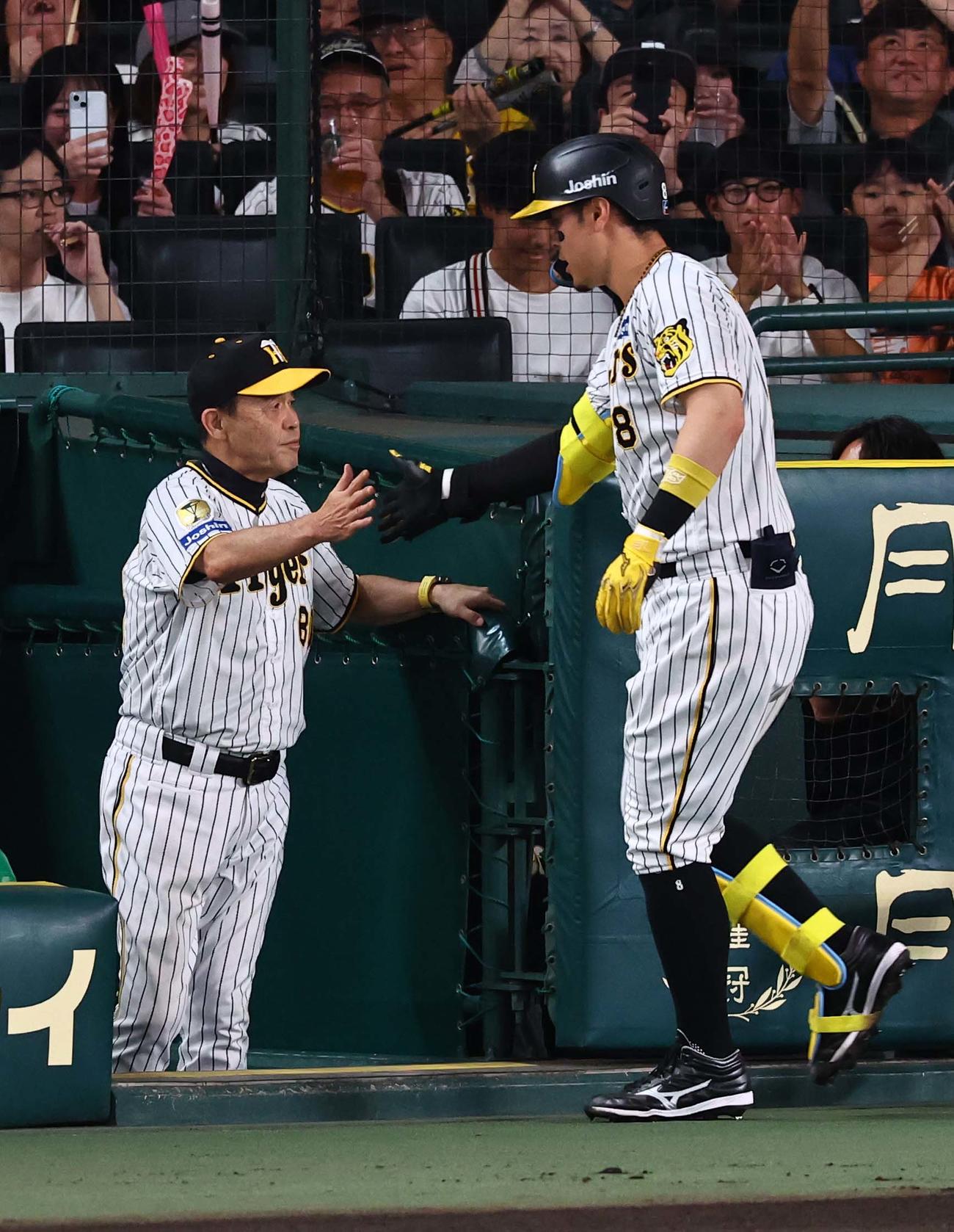 阪神対ヤクルト　2回裏阪神1死、右越えに同点ソロ本塁打を放った佐藤輝（右）とハイタッチする岡田監督（撮影・上田博志）