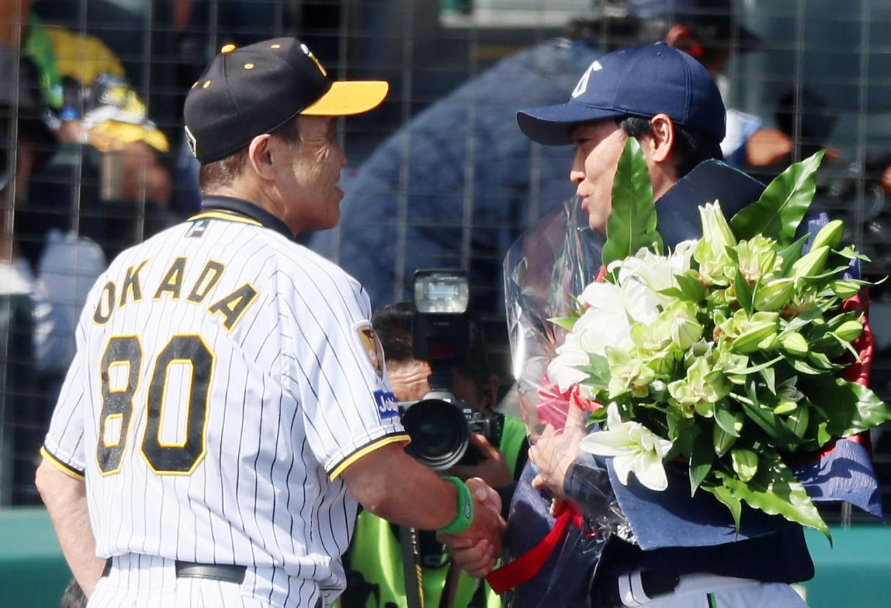阪神対ヤクルト　引退するヤクルト青木（右）に記念の花束を手渡した阪神岡田監督（撮影・加藤哉）