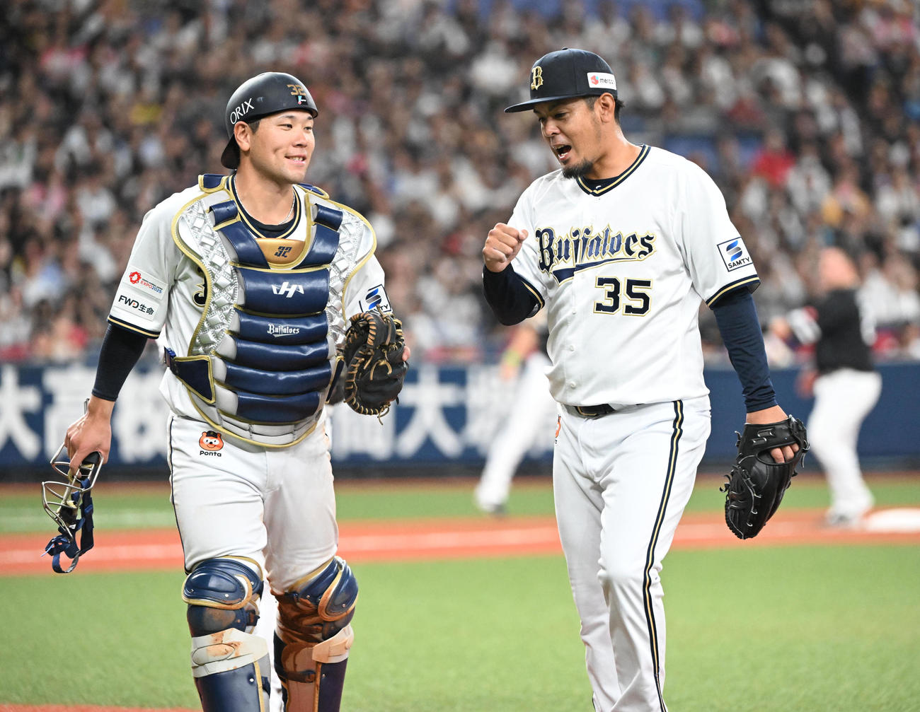 オリックス対ソフトバンク　8回表ソフトバンク2死一、二塁、中村晃を右飛に抑え無失点、捕手福永（左）とタッチする比嘉（撮影・和賀正仁）
