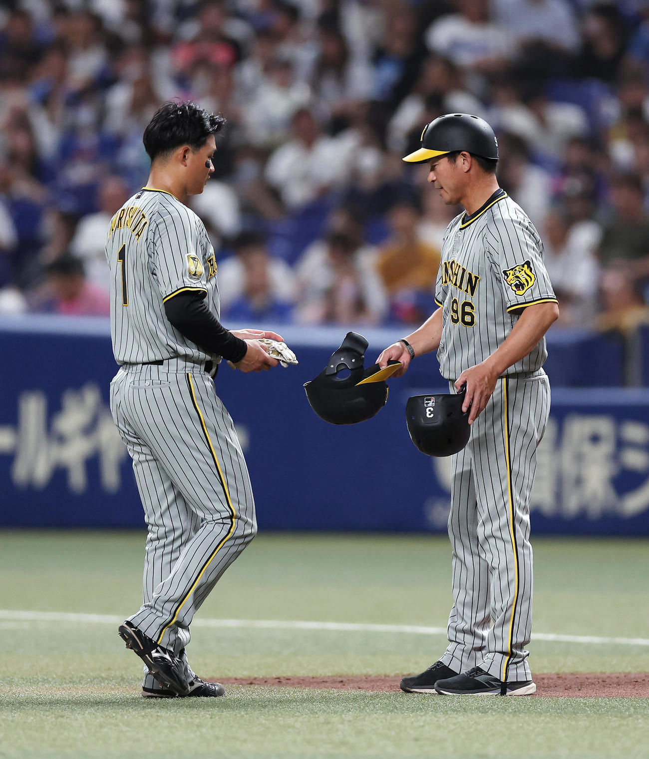 中日対阪神　3回表阪神2死一、二塁、打者佐藤輝の時、捕手加藤匠のけん制でアウトとなり、筒井コーチ（右）と言葉を交わす森下（撮影・前田充）