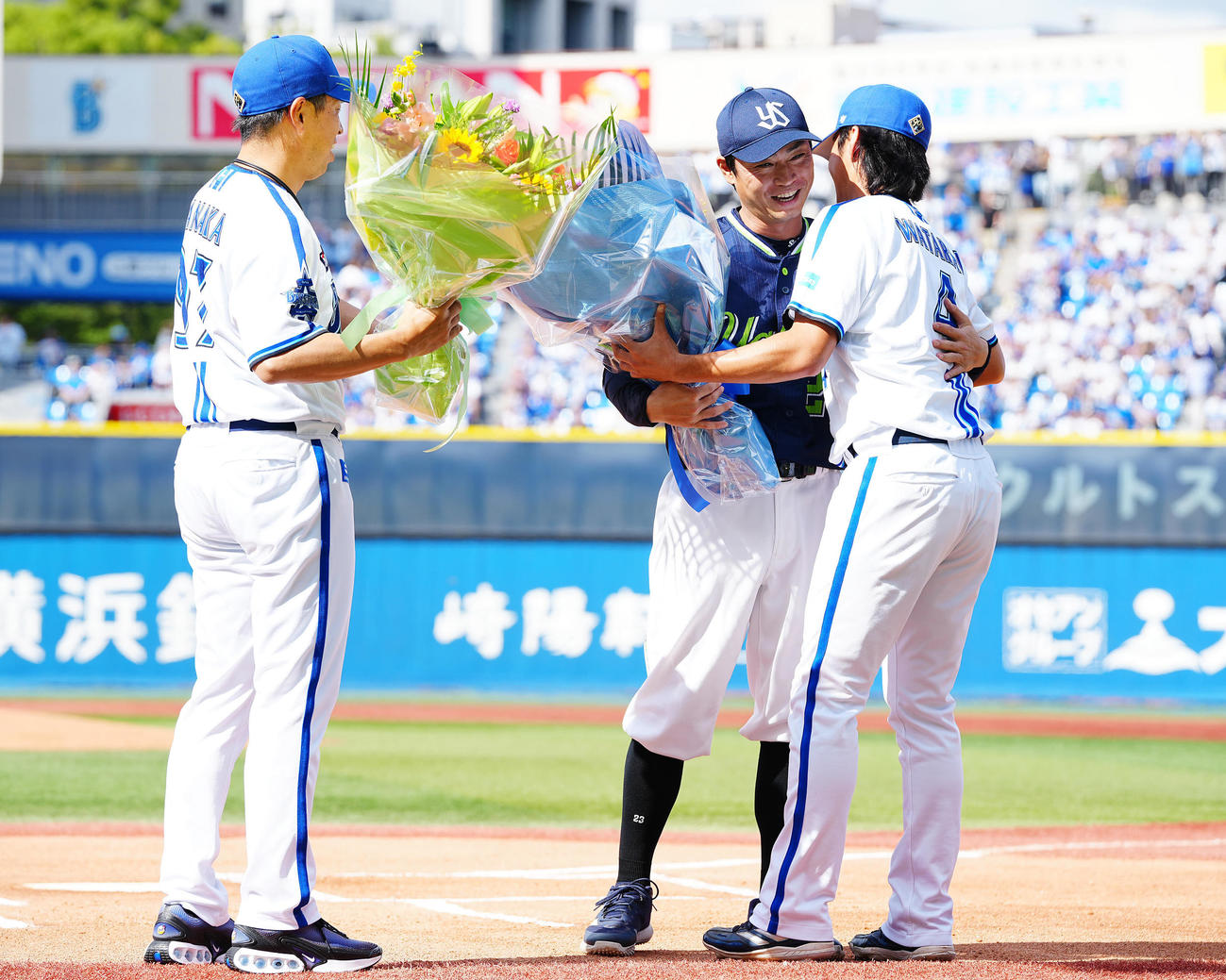 DeNA対ヤクルト　試合前、DeNA田中コーチ（左）、度会（右）から花束を受け取るヤクルト青木（撮影・垰建太）