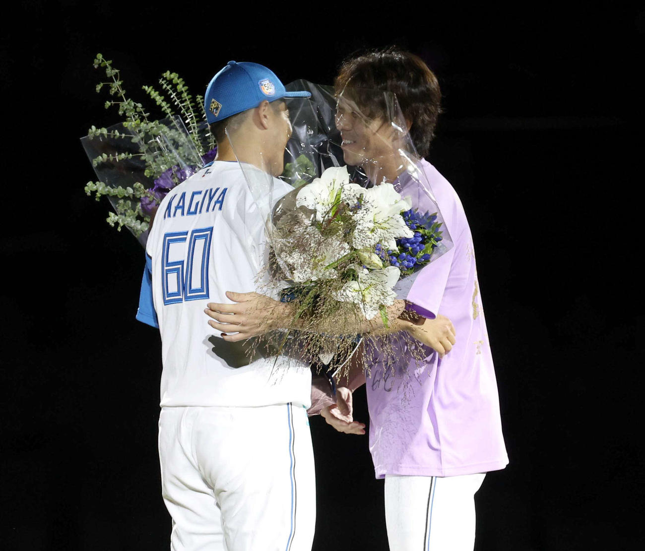引退セレモニーで宮西から花束を受け取る鍵谷（撮影・黒川智章）