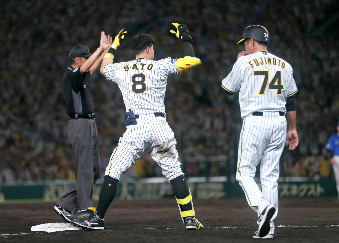 阪神対DeNA 7回裏阪神2死一、二塁、佐藤輝（中央）は左2点適時三塁打を放ち三塁でポーズする（撮影・上山淳一）