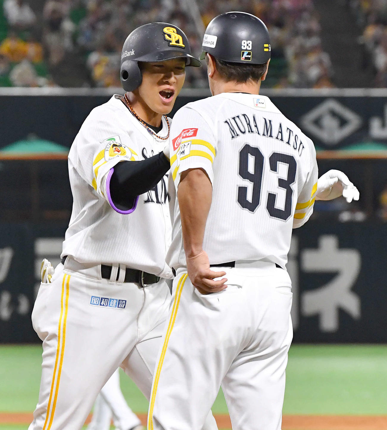 ソフトバンク対オリックス　1回裏ソフトバンク無死一塁、右前安打を放ち、村松コーチ（右）とタッチを交わす柳田（撮影・岩下翔太）