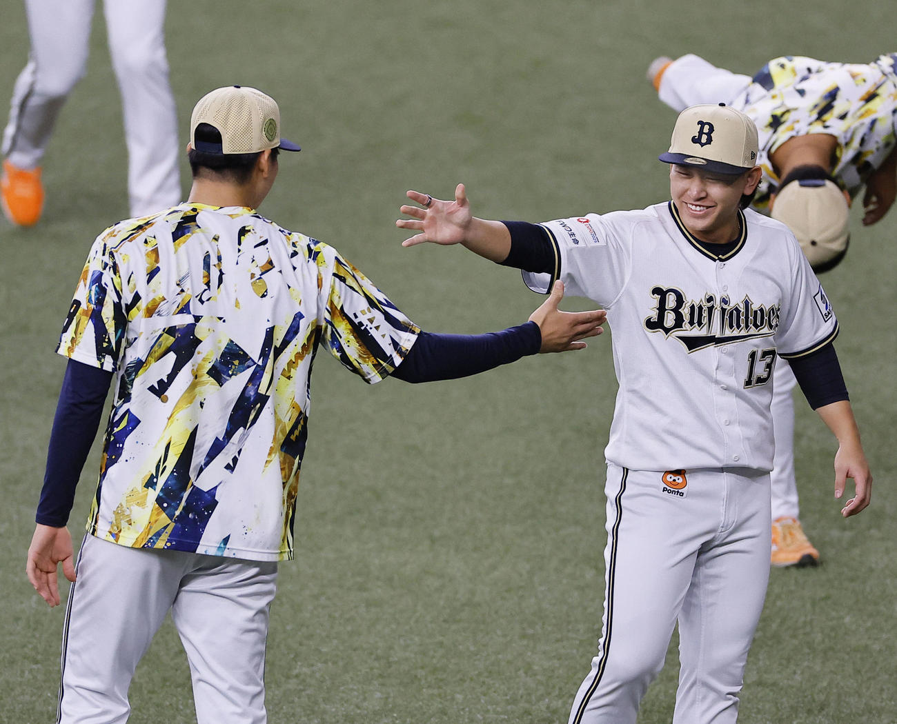 4日、山下（左）とタッチを交わすオリックス宮城