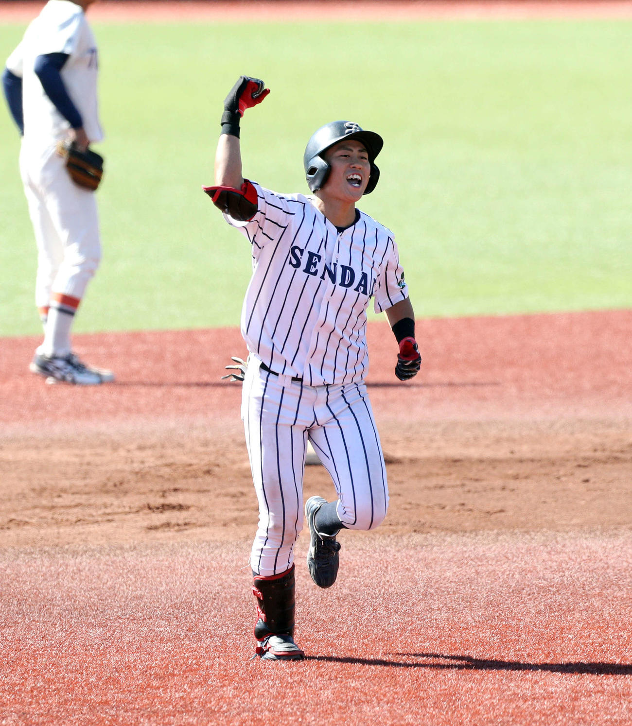 仙台大対東北福祉大　6回表仙台大1死一、二塁で右中間へ先制の3点本塁打を放ち、ガッツポーズでダイヤモンドを一周する仙台大・田口（撮影・木村有優）