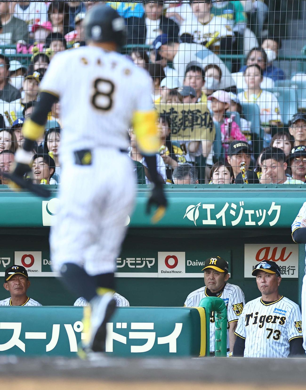 阪神対DeNA 7回裏阪神無死、三振に倒れた佐藤輝。岡田監督（右から2人目）はベンチで厳しい表情を見せる（撮影・上田博志）