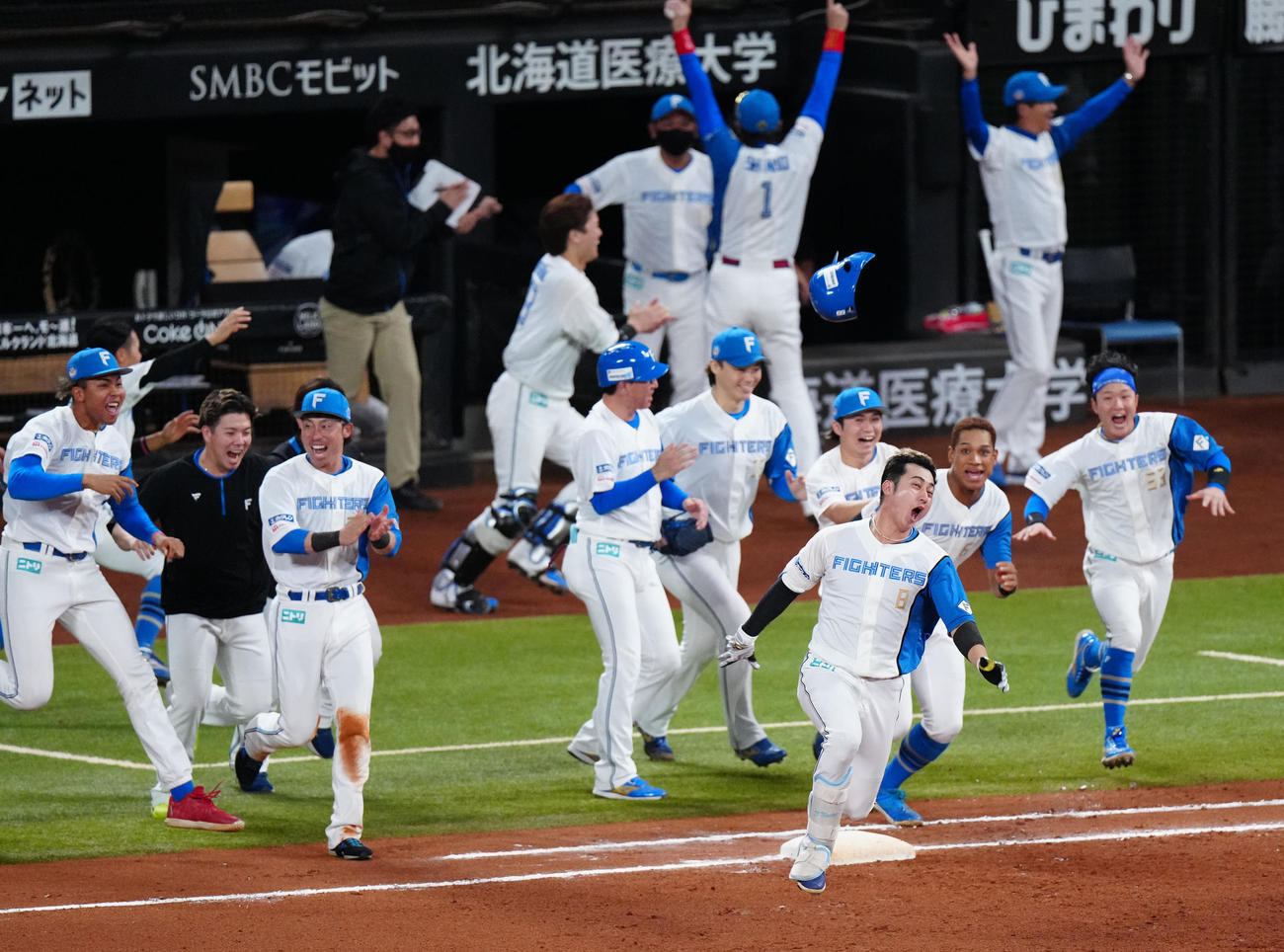 日本ハム対ロッテ　10回裏日本ハム2死一、三塁、サヨナラ適時打を放ち歓喜する浅間（手前右）（撮影・江口和貴）