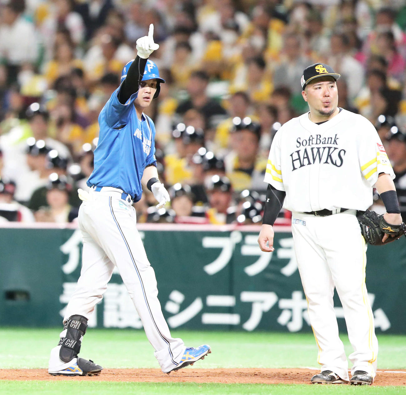 ソフトバンク対日本ハム　3回表日本ハム無死一塁、伏見（左）は左前打を放ちポーズを決める。一塁手山川（撮影・鬼束羽瑠菜）