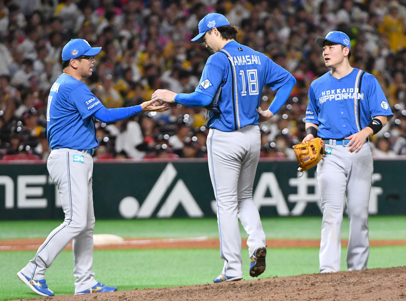 ソフトバンク対日本ハム　4回裏、周東に勝ち越し打を打たれて降板となった山崎（中央）は、建山コーチにボールを手渡してベンチへ戻る（撮影・岩下翔太）