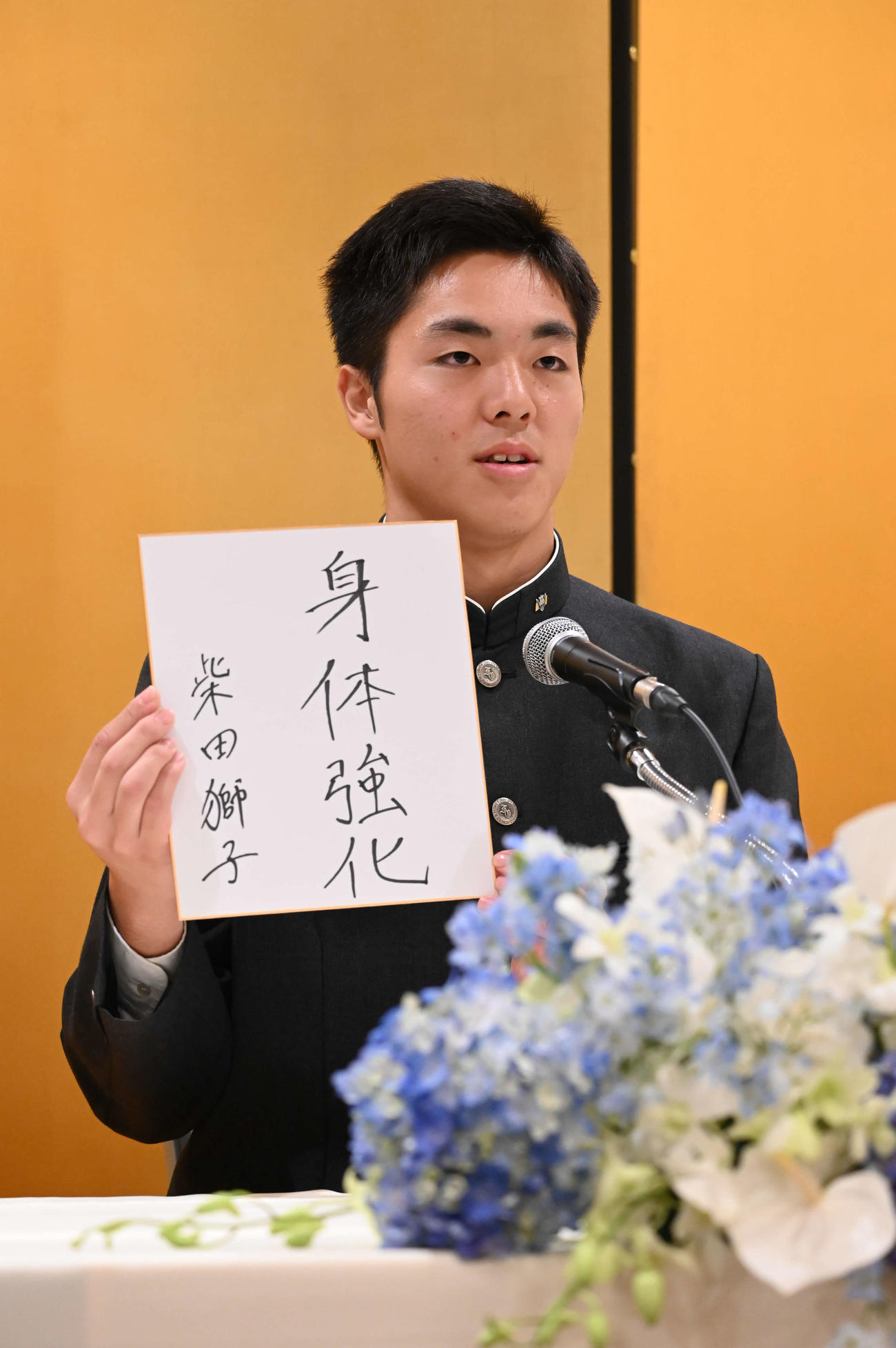 記者会見で色紙を掲げる柴田（撮影・林敢治）