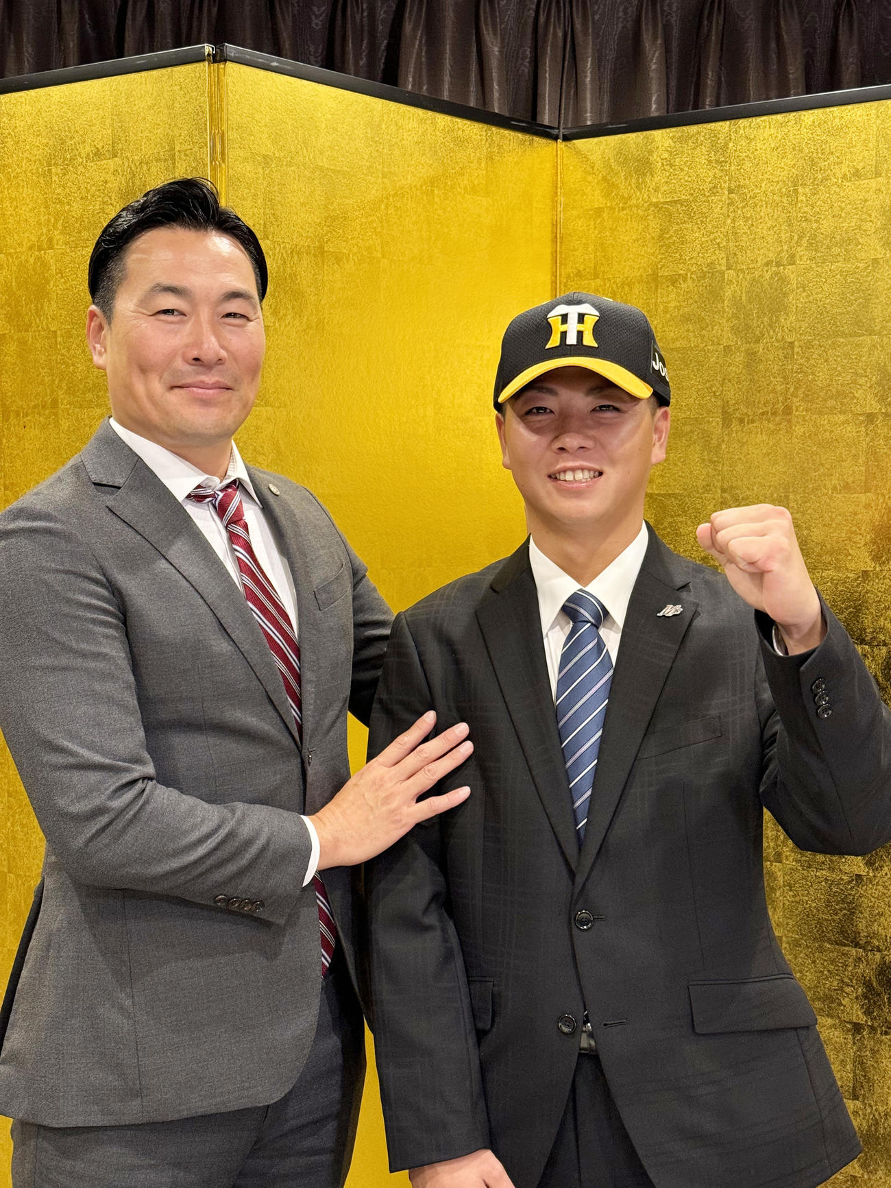 阪神との仮契約を終え笑顔をみせる育成4位NLB石川の川崎、左は筒井スカウト（球団提供）
