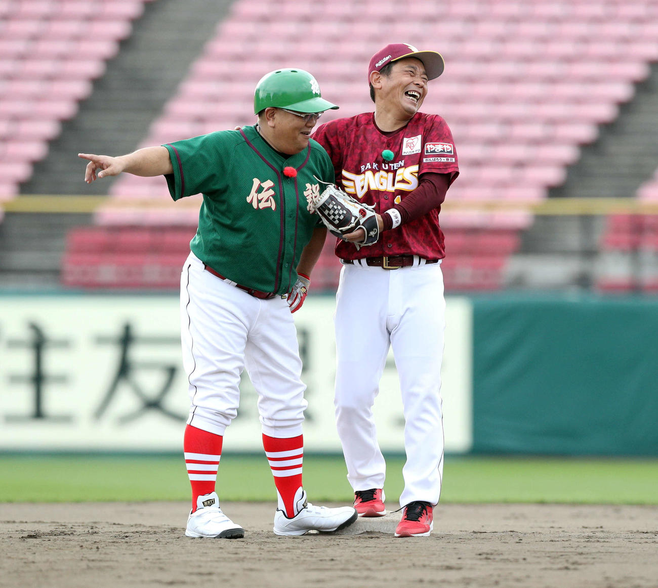 楽天OB対サンド軍団　ベース上で談笑するサンド軍団・伊達（左）と草野氏（撮影・木村有優）
