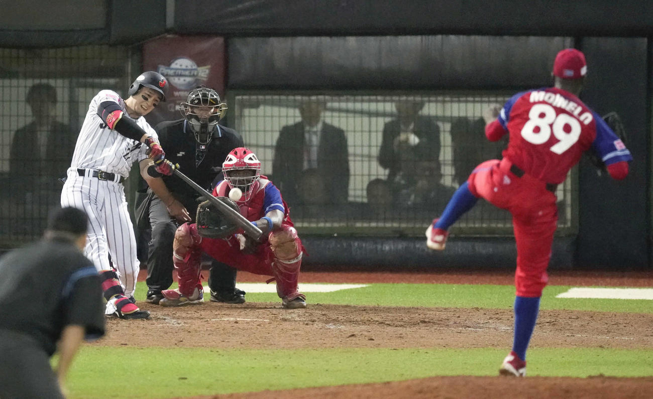 日本対キューバ　8回裏日本1死一、三塁、栗原が勝ち越しの左犠飛を放つ（共同）