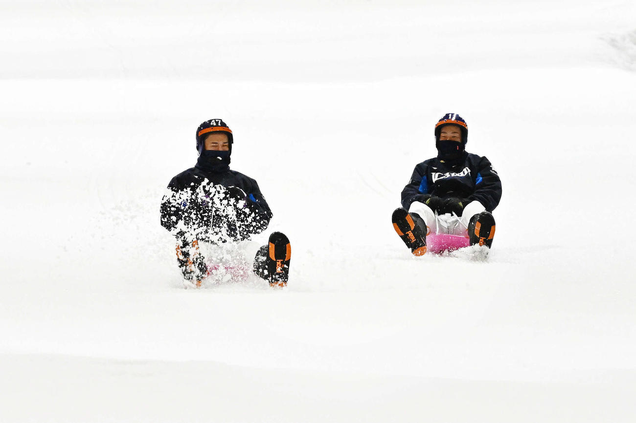狭山スキー場でそりに乗って登場した西武杉山（左）と上田（撮影・滝沢徹郎）