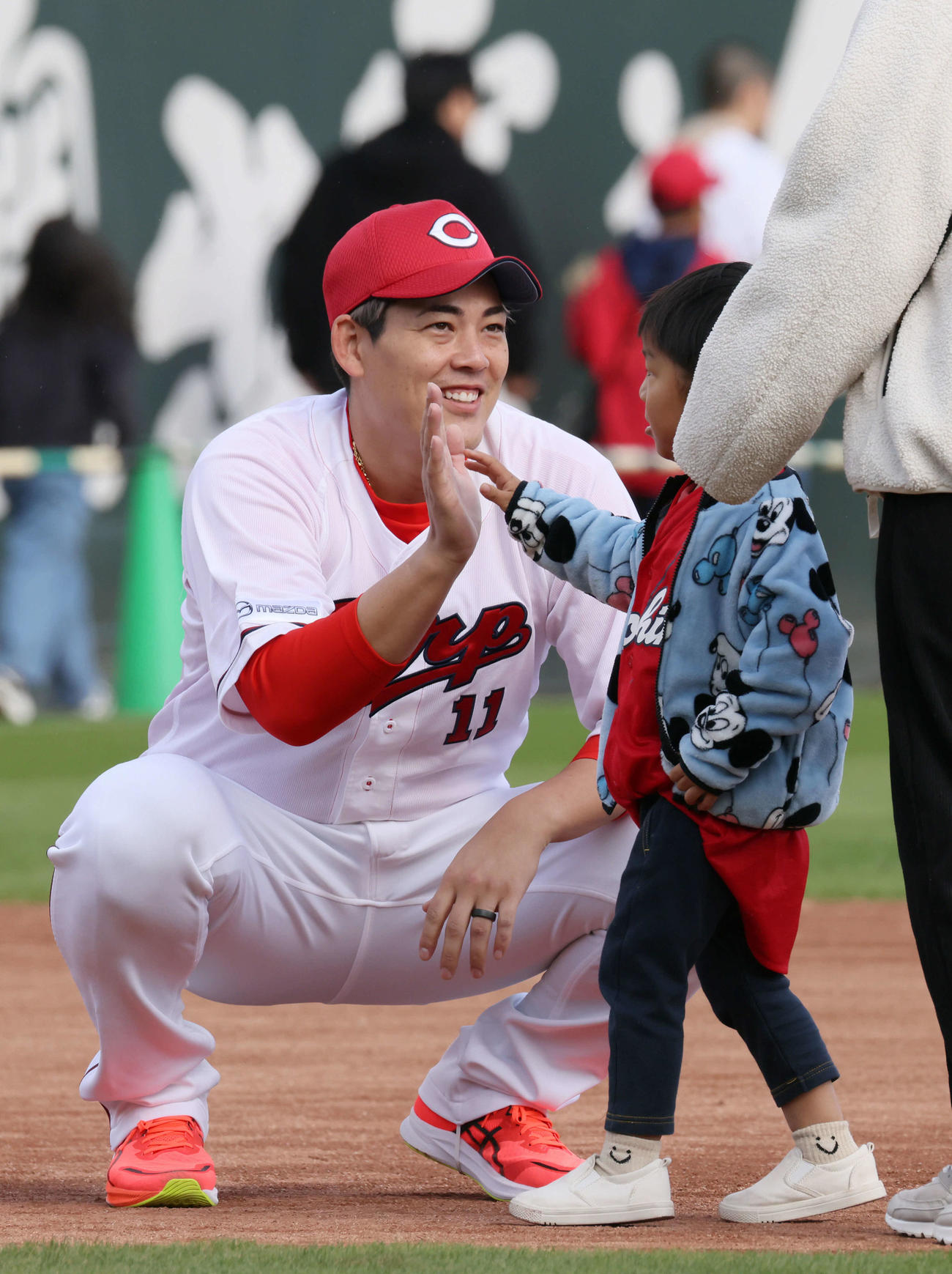 ファン感謝デーでファンとハイタッチする広島九里（撮影・加藤孝規）
