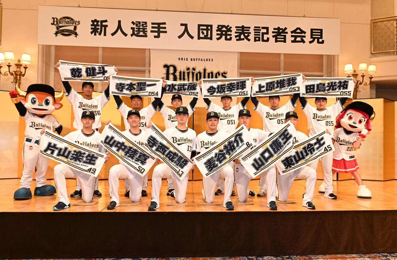 オリックス入団発表後、タオルを手にポーズを取る前列左から6位片山楽生、4位山中稜真、2位寺西成騎、1位麦谷祐介、3位山口廉王、5位東山玲士、後列左から育成6位乾健斗、同4位寺本聖一、同2位清水武蔵、同1位今坂幸暉、同3位上原堆我、同5位田島光祐（撮影・和賀正仁）