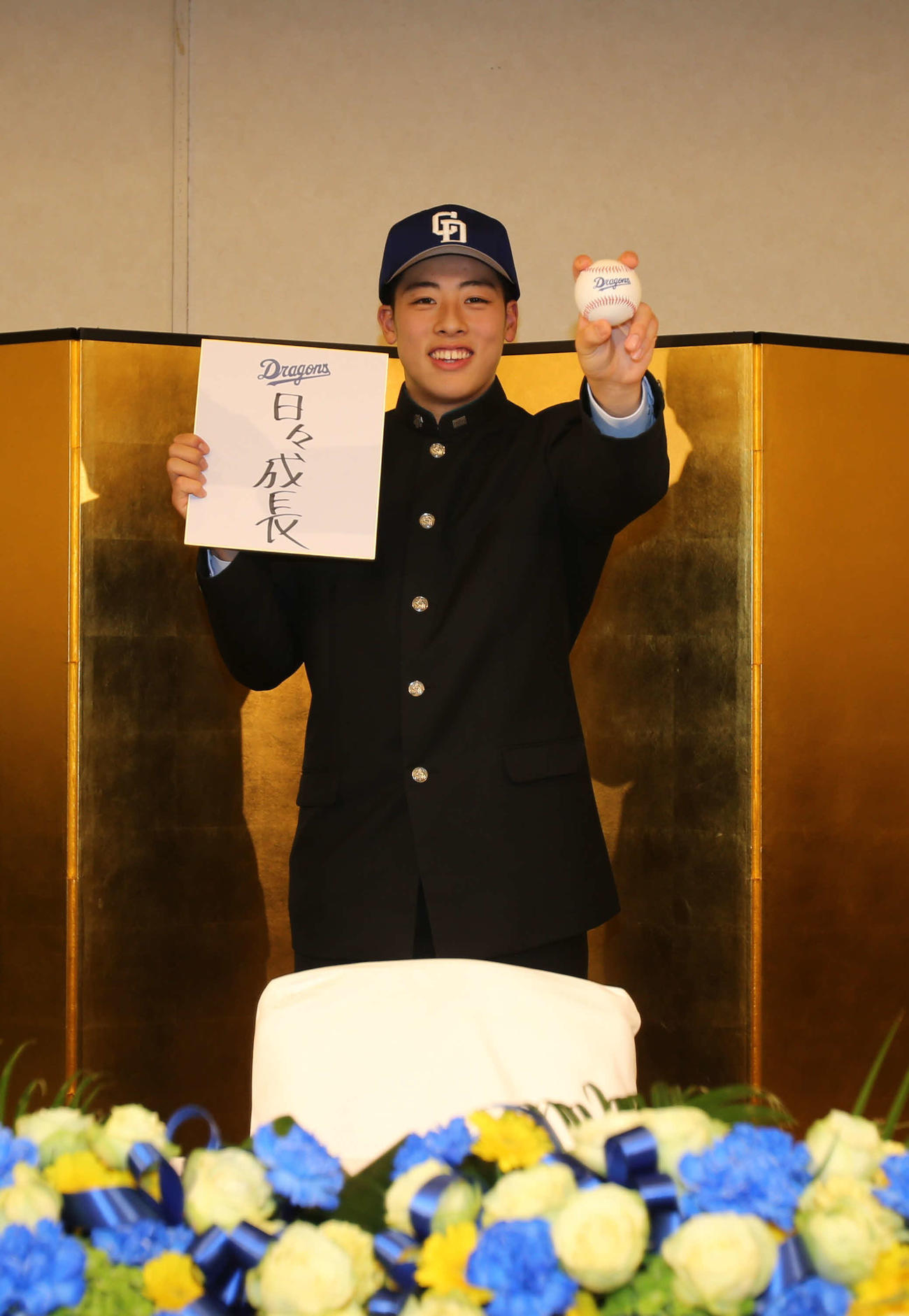 中日5位指名の北照・高橋投手（左）は、「日々成長」と抱負を直筆した色紙を持って笑顔（撮影・中島洋尚）