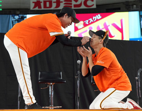 愛犬に扮した門脇(右)とじゃれ合う巨人山崎伊(撮影・たえ見朱実)