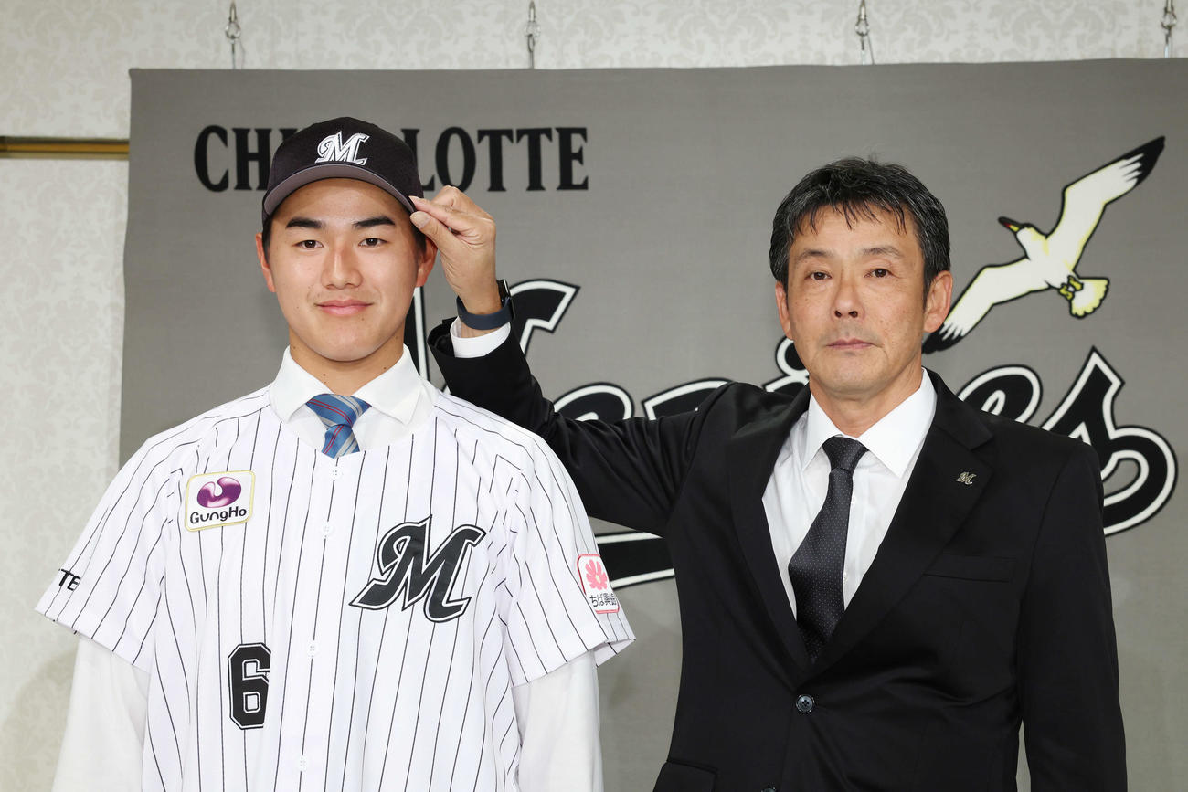 ロッテ福沢スカウト（右）と記念撮影するドラフト1位の青学大・西川（撮影・宮地輝）