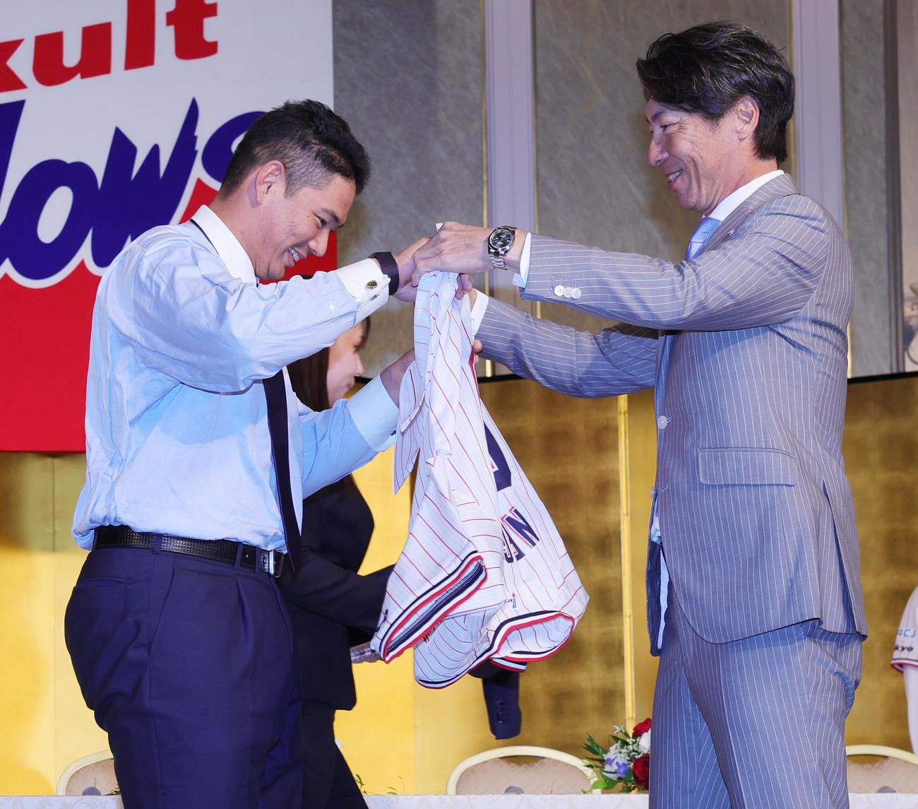 ヤクルトの新入団選手発表で、高津監督（右）からユニホームを贈呈される根岸（撮影・野上伸悟）