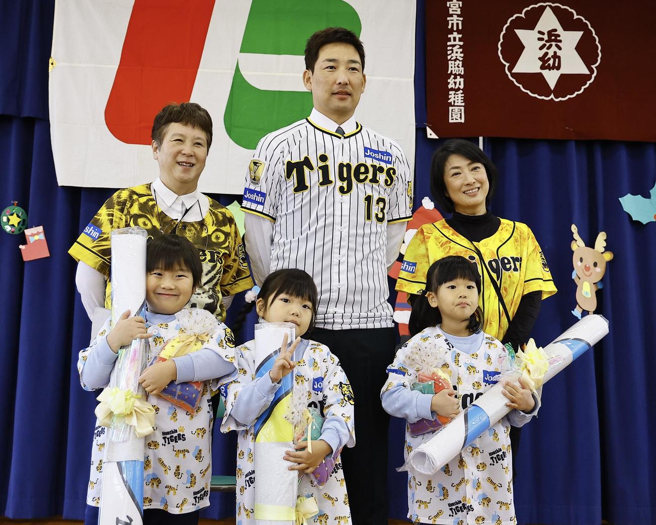 玩具を寄贈し、子供たちと写真に納まる阪神岩崎優（撮影・藤尾明華）＝2024年12月5日