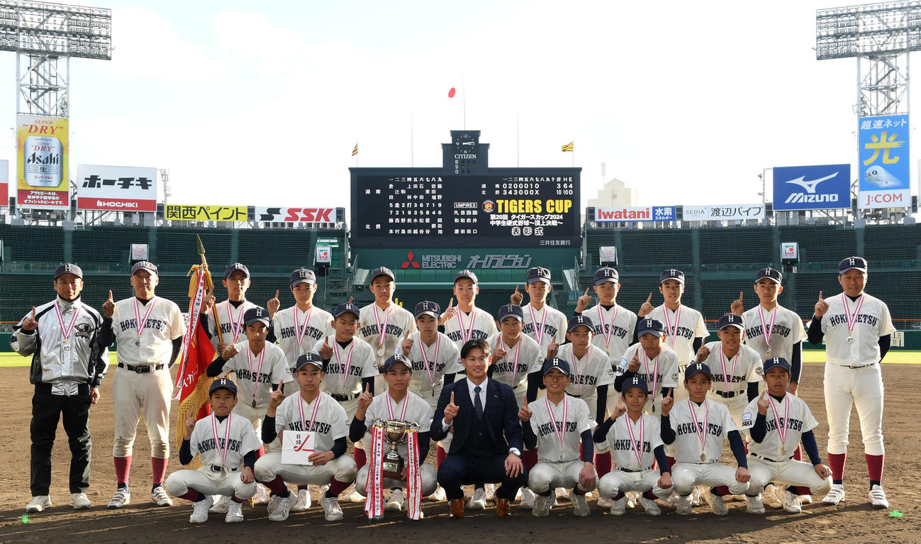 タイガースカップに優勝した北摂ナインと記念撮影を行う阪神及川（撮影・前岡正明）