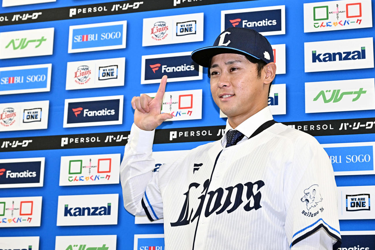 入団会見でポーズを決める西武平沢（撮影・滝沢徹郎）