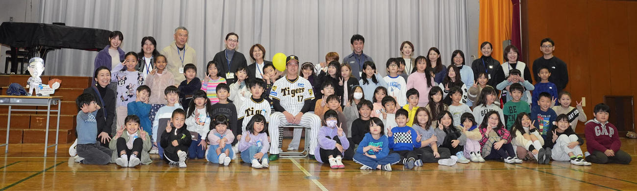 汐入小学校の子どもたちと記念撮影に納まる阪神青柳（撮影・鈴木みどり）