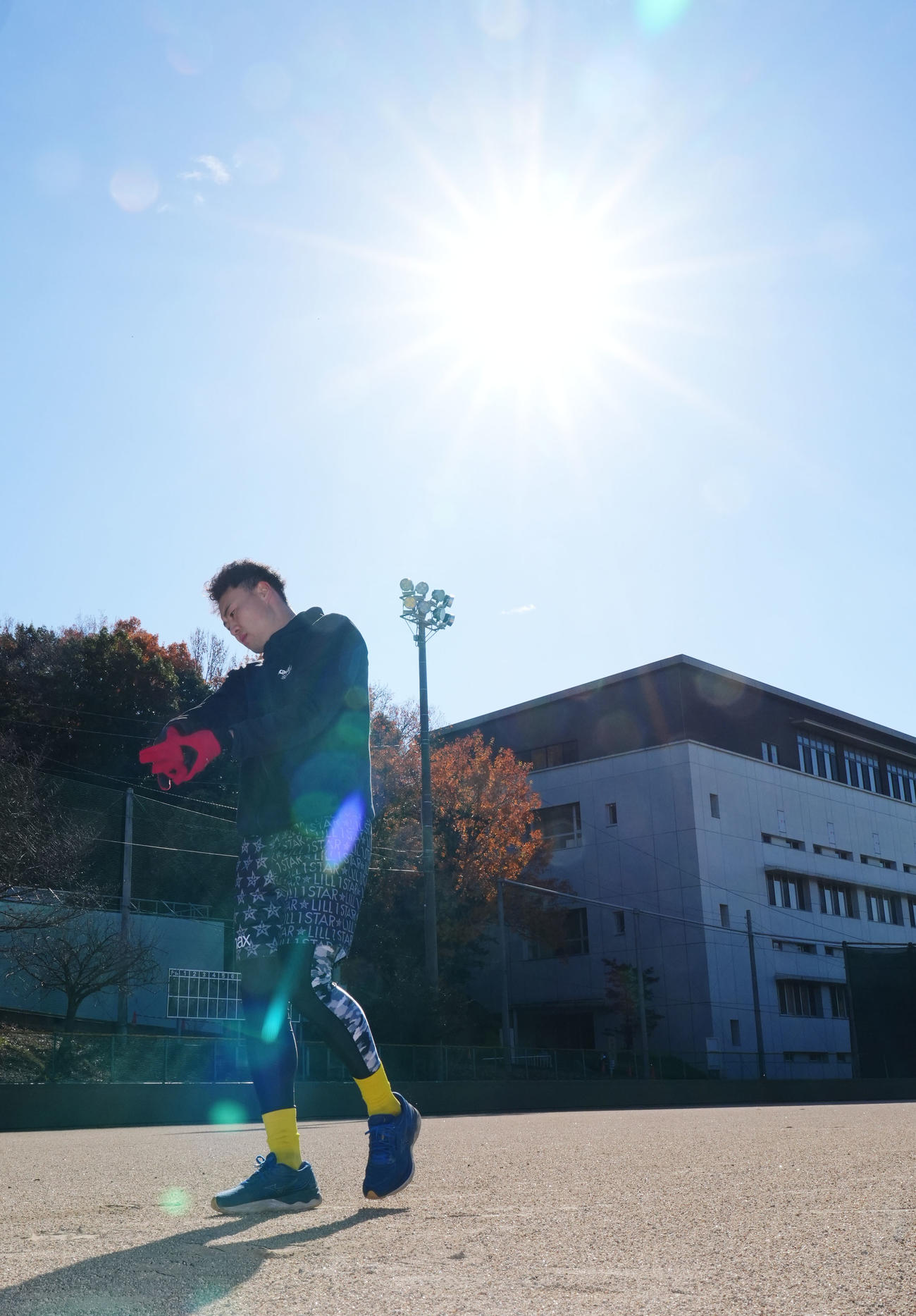 好天に恵まれ朝日を浴びながら自主トレを行う佐野（撮影・森本幸一）